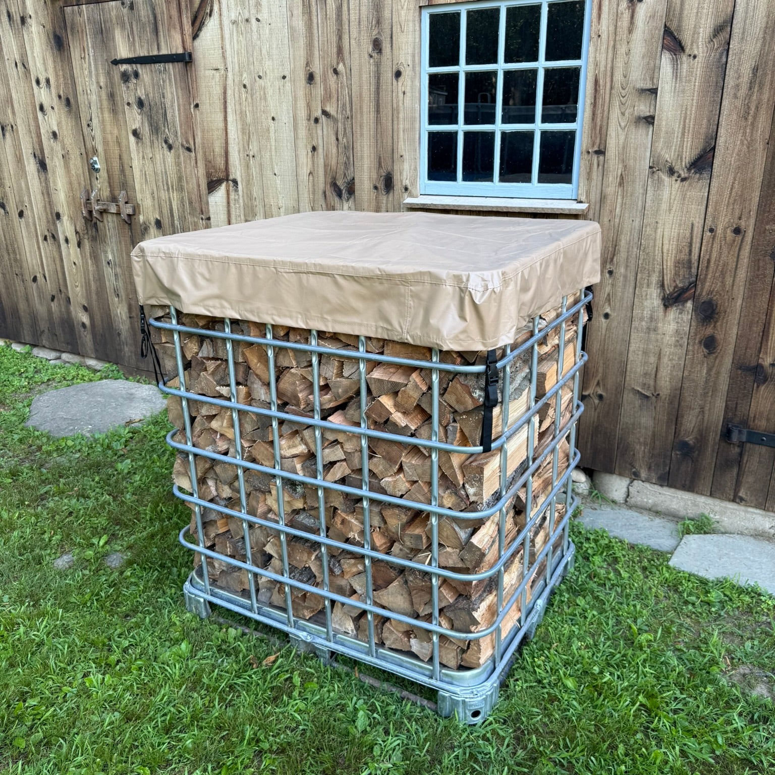 Firewood storage unit using an IBC tote with a cordwood cover on top placed outside