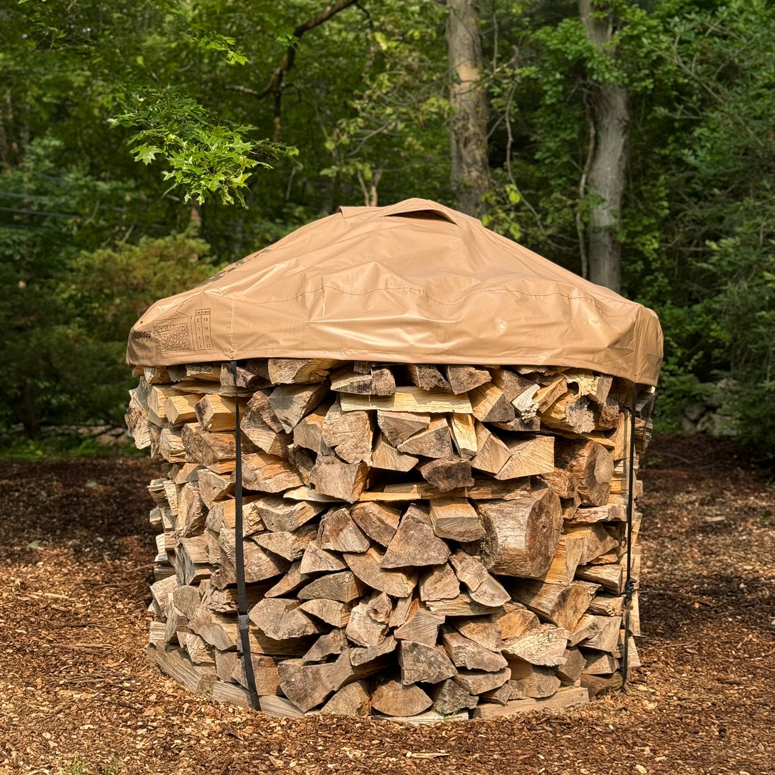 6ft diameter round stack of firewood neatly stacked with a cordwood cover