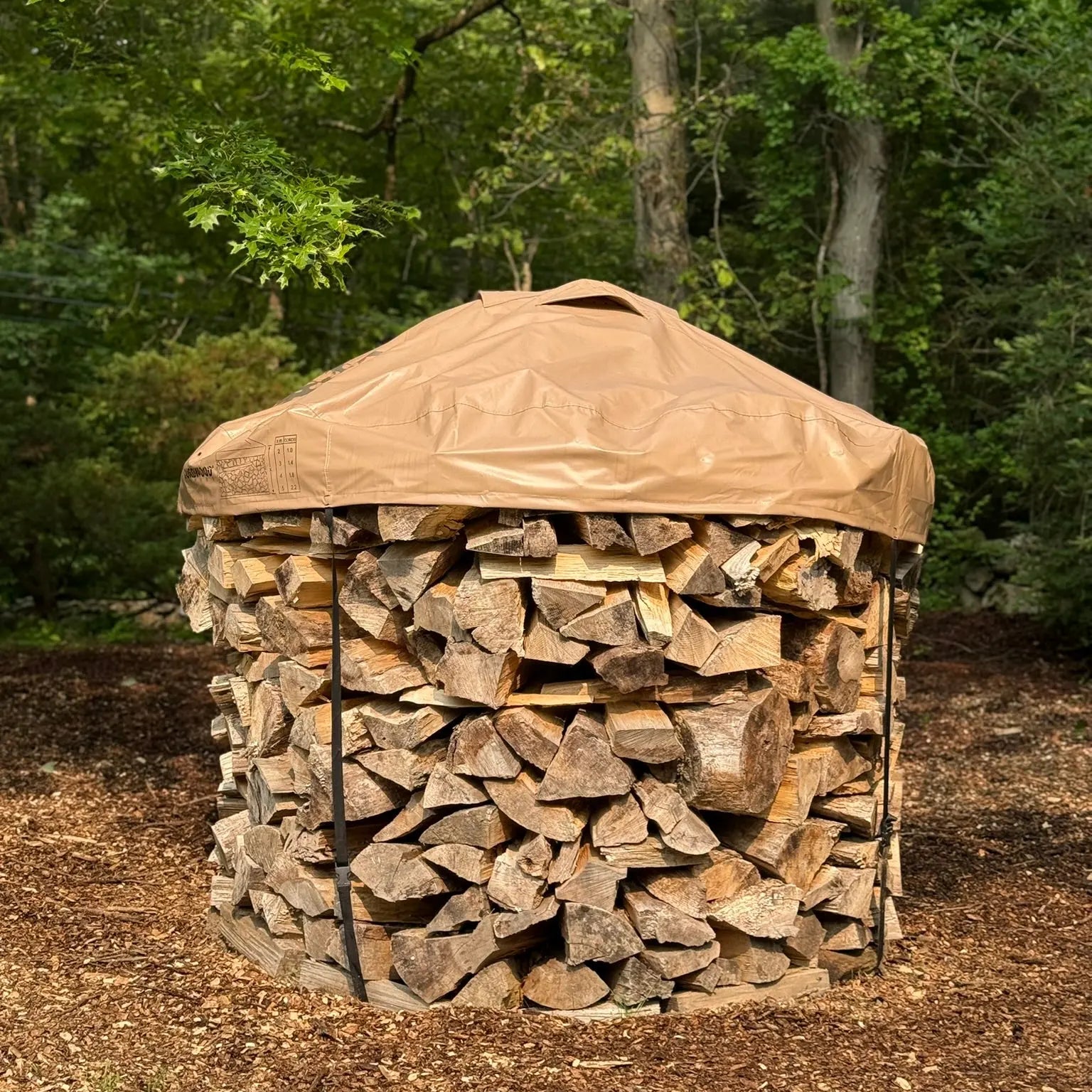6ft diameter round stack of firewood neatly stacked with a cordwood cover