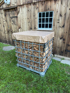 Firewood storage unit using an IBC tote with a cordwood cover on top placed outside